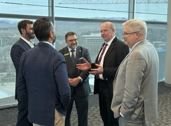 Five men in conversation at an event in Boise, Idaho